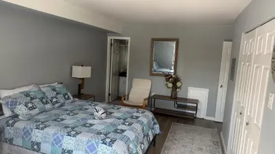 a bedroom with a bed and a chair in it at comfort for you in Elkins Park