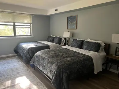 a bedroom with two beds and a window at comfort for you in Elkins Park