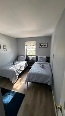 a bedroom with two beds and a window at comfort for you in Elkins Park