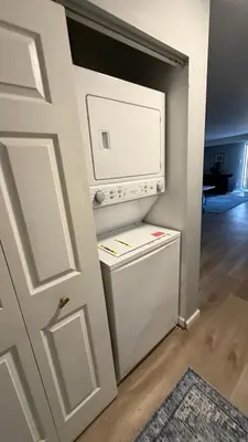 a small refrigerator in a kitchen next to a door at comfort for you in Elkins Park