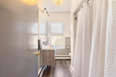 a bathroom with a sink and a shower curtain at Jim Thorpe Center House - Families and Groups Welcome - Walkable in Jim Thorpe