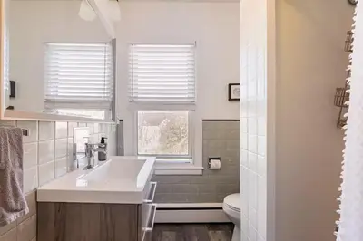 a white bathroom with a sink and a toilet at Jim Thorpe Center House - Families and Groups Welcome - Walkable in Jim Thorpe