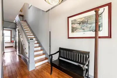 a hallway with a bench and stairs in a house at Jim Thorpe Center House - Families and Groups Welcome - Walkable in Jim Thorpe