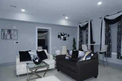 a living room with a couch and a chair at Big Apple room 34 in West New York