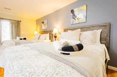 a bedroom with two beds with white pillows at Loft at Downtown Newark in Newark