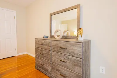 a dresser with a mirror on top of it at Loft at Downtown Newark in Newark