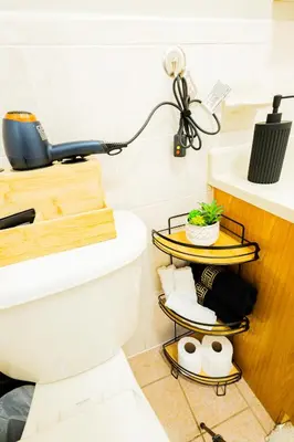 a bathroom with a toilet and a phone on the wall at Loft at Downtown Newark in Newark