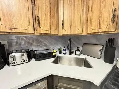 a kitchen with a sink and a counter top at 3BR home in Jersey city ! near metlife & NYC train in Jersey City