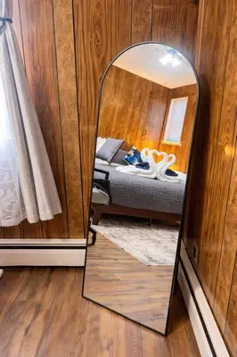 a mirror in the corner of a room with a bed at 3BR home in Jersey city ! near metlife & NYC train in Jersey City