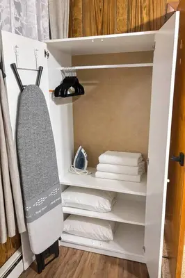 a closet with white towels and a shelf with towels at 3BR home in Jersey city ! near metlife & NYC train in Jersey City