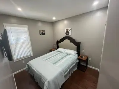 a bedroom with a large bed and a window at Elegant 3BR Stay | Mins to NYC • Near Dream Mall in Newark