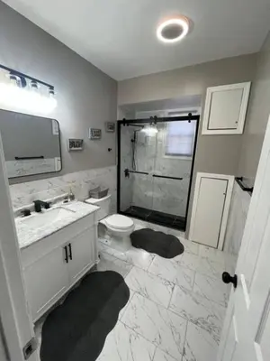a bathroom with a sink and a toilet and a shower at Elegant 3BR Stay | Mins to NYC • Near Dream Mall in Newark