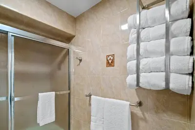 a bathroom with a shower and towels on a wall at Cozy Retreat 15Min to NYC, FIFA, Mall,FREE Parking - Apartment in North Bergen