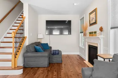 a living room with a couch and a fireplace at Lakefront Game Room Hot Tub Close to it All in Lake Harmony