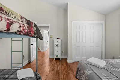 a bedroom with a bed and a white door at Lakefront Game Room Hot Tub Close to it All in Lake Harmony