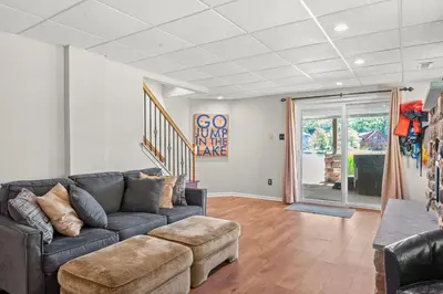 a living room with a couch and a table at Lakefront Game Room Hot Tub Close to it All in Lake Harmony