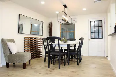 a dining room with a table and chairs and a mirror at Spacious New4BR 3BA 2kit GameRm Firepit Amenity in Tobyhanna