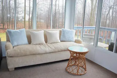 a living room with a couch and a table at Spacious New4BR 3BA 2kit GameRm Firepit Amenity in Tobyhanna