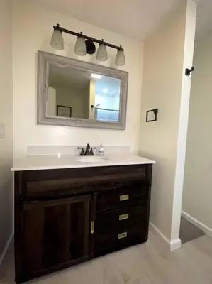 a bathroom with a sink and a mirror at Spacious New4BR 3BA 2kit GameRm Firepit Amenity in Tobyhanna