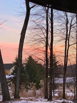 a sunset view from the porch of a house in the snow at Inn Harmony- Cabin with Game Room Hot Tub Firepit in Lake Harmony