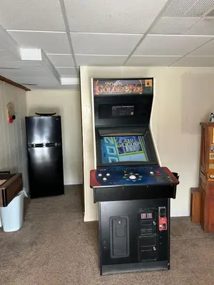 a video game machine sitting in a room at Inn Harmony- Cabin with Game Room Hot Tub Firepit in Lake Harmony