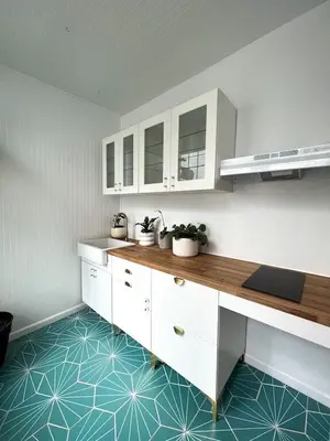 a kitchen with white cabinets and a blue floor at Home for 8, Parking & Patio in Phoenixville