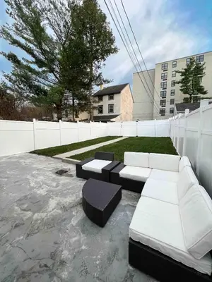 a patio with couches and tables in a backyard at Retreat with Parking Sleeps 6 in Phoenixville