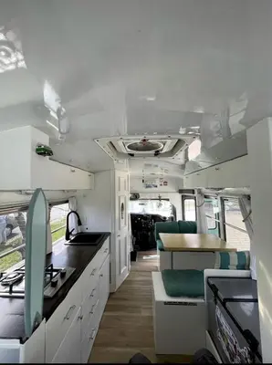 an interior view of an rv with a kitchen at Coastal Style Bus Farm Retreat with Pond Dock and Peaceful Nature Views in Stillwater, Pennsylvania in Stillwater
