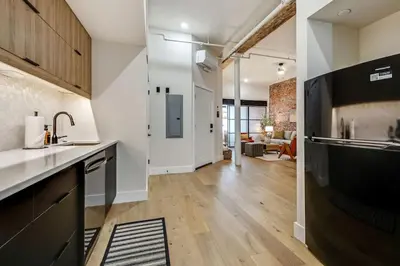 an open kitchen and living room in a loft at Cozy & Historic Old City 2 Bedroom - Sleeps 5 in Philadelphia
