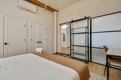 a bedroom with a large white bed and a desk at Cozy & Historic Old City 2 Bedroom - Sleeps 5 in Philadelphia