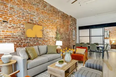 a living room with a couch and a brick wall at Cozy & Historic Old City 2 Bedroom - Sleeps 5 in Philadelphia