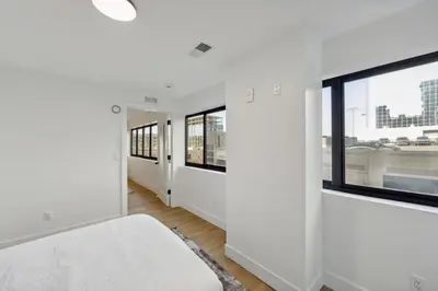 a room with white walls and windows and a bed at Market View Residence stunning 1bd Apt in Wilmington