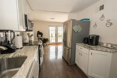 a kitchen with a refrigerator and a sink at Luxurious 4BD APT EV Parking in North Bergen