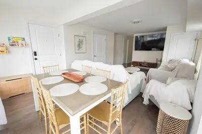 a living room with a table with chairs and a couch at Luxurious 4BD APT EV Parking in North Bergen