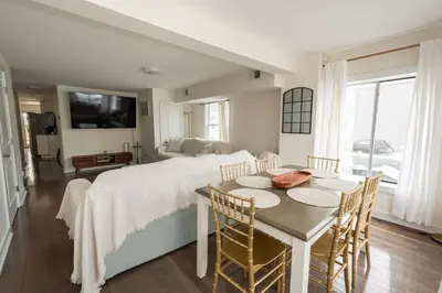 a bedroom with a bed and a table and chairs at Luxurious 4BD APT EV Parking in North Bergen