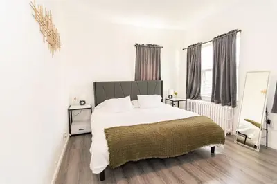 a bedroom with a large white bed and a window at Luxury North Bergen 3 BR APT in North Bergen