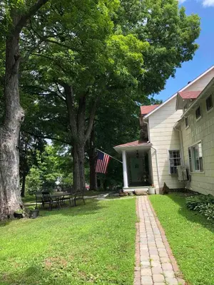 a house with an american flag and a picnic table at 20 min Woodbury Outlet & USMA 35 min Mt Creek in Chester