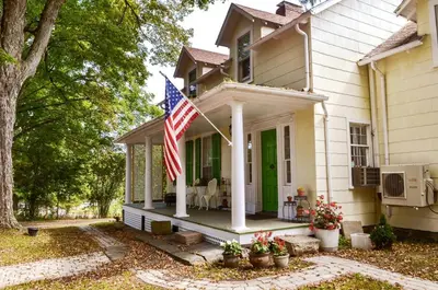 a house with an american flag on the front porch at 20 min Woodbury Outlet & USMA 35 min Mt Creek in Chester