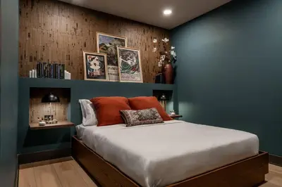 a bedroom with a large bed with blue walls at Cozy Artisan Loft with Literary Charm - Book Binder in Philadelphia