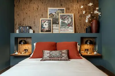 a bedroom with a bed with two lamps and pictures on the wall at Cozy Artisan Loft with Literary Charm - Book Binder in Philadelphia