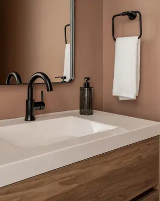 a white sink in a bathroom with a mirror at Cozy Artisan Loft with Literary Charm - Book Binder in Philadelphia