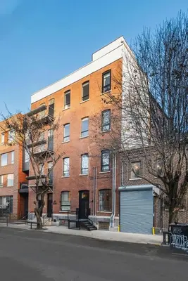 a large brick building on the side of a street at Cozy Artisan Loft with Literary Charm - Book Binder in Philadelphia