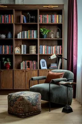 a living room with a chair and a book shelf at Cozy Artisan Loft with Literary Charm - Book Binder in Philadelphia