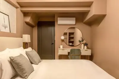 a bedroom with a white bed and a mirror at Eclectic Artisan Loft With Pvt Parking - The Luminaire in Philadelphia
