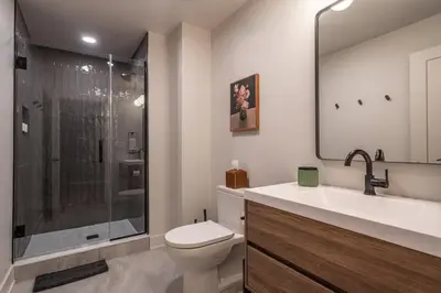 a bathroom with a toilet and a sink and a shower at Stunning Artisan Loft Chic & Modern - The Botanist in Philadelphia