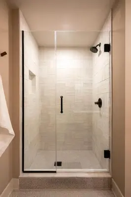 a shower with a glass door in a bathroom at Stunning Artisan Loft Chic & Modern - The Botanist in Philadelphia