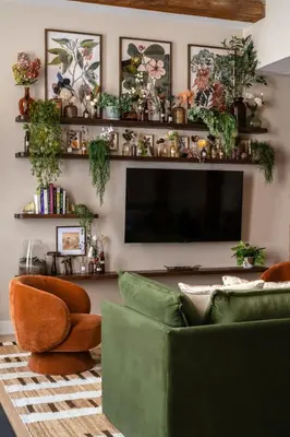 a living room with a green couch and a flat screen tv at Stunning Artisan Loft Chic & Modern - The Botanist in Philadelphia