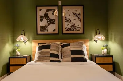 a bedroom with a large bed with two lamps at Stunning Artisan Loft Chic & Modern - The Botanist in Philadelphia