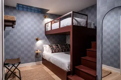 a small bedroom with a bunk bed and a staircase at Elegant Artisan Loft W Private Parking - The Weaver in Philadelphia