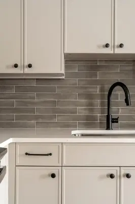 a kitchen with white cabinets and a sink at Luxurious Artisan Loft w Chic Design - The Tanner in Philadelphia